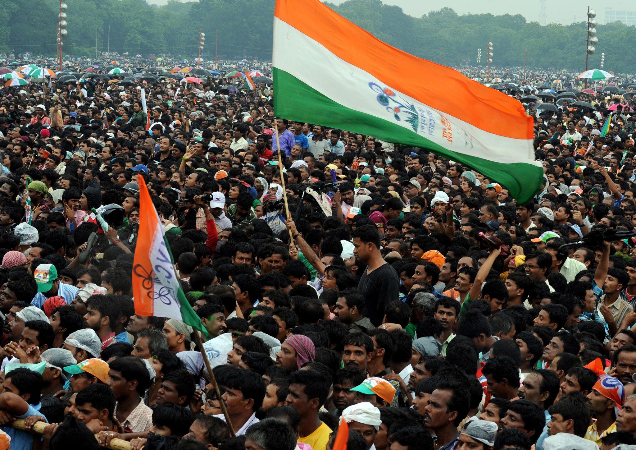 Massive political crowd gathered with flags in West Bengal showing large-scale public participation,