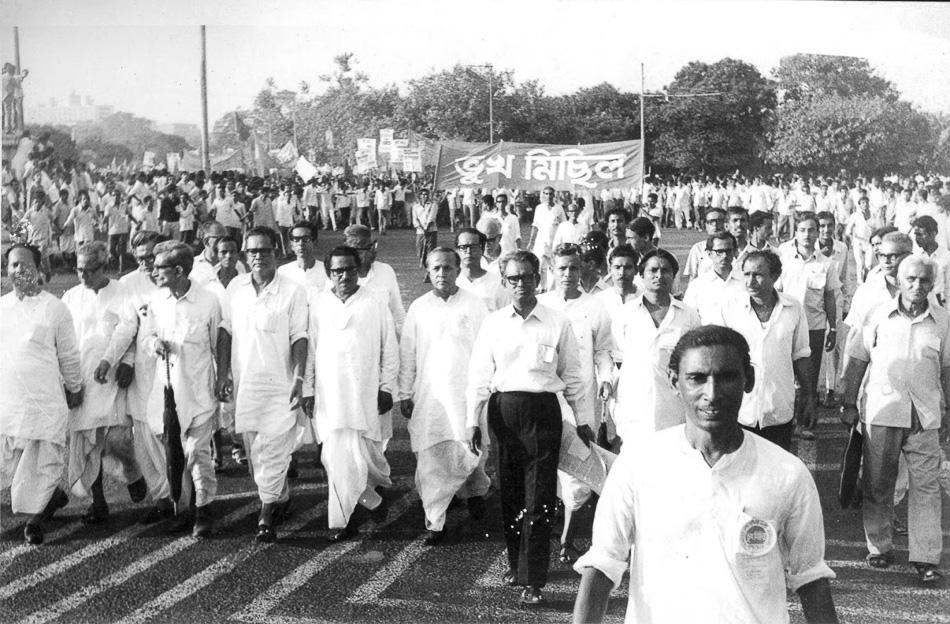Large group of people marching together in a political rally in West Bengal during the mid-20th century,
